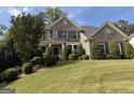 Charming brick home featuring a well-maintained lawn and beautiful landscaping for great curb appeal at 2750 Brentwood Estates Ct, Cumming, GA 30041