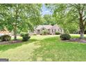 Lovely brick home featuring a well-kept lawn, mature trees, and neat landscaping at 186 Ashley Dr, Mcdonough, GA 30252