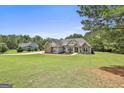 Spacious craftsman-style house featuring an expansive front yard with lush landscaping and long driveway at 45 Coral Ridge Ct, Palmetto, GA 30268