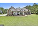 Inviting single Gathering home with stone accents, manicured landscaping, and well-maintained lawn at 45 Coral Ridge Ct, Palmetto, GA 30268