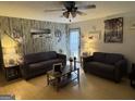 Cozy living room with warm wood floors, two comfortable sofas, and unique wall decor at 435 Rosehill Dr, Mcdonough, GA 30253