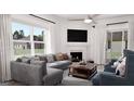 Inviting living room featuring a cozy fireplace, elegant furniture, and a view of the backyard at 1208 Trombone Way # 106, Mcdonough, GA 30252