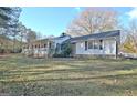 This home has a well-maintained lawn and beautiful surrounding trees providing a serene setting at 435 Crabapple Rd, Fayetteville, GA 30215