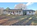 Charming home with a welcoming front porch and a beautiful lawn on a sunny day at 435 Crabapple Rd, Fayetteville, GA 30215