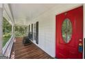 Inviting front porch with rocking chairs and a vibrant red front door at 230 Vienna Way, Douglasville, GA 30134