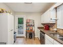 Bright kitchen with stainless steel appliances and a door to the backyard deck at 230 Vienna Way, Douglasville, GA 30134