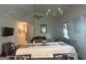 Dining room with modern chandeliers, ceiling fan, and seamless access to a cozy living area at 2635 Lovejoy Crossing Ln, Hampton, GA 30228