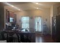 Well-lit kitchen with dark cabinetry, stainless steel microwave, and open view to the backyard at 2635 Lovejoy Crossing Ln, Hampton, GA 30228