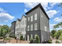 Modern three-story townhome with landscaped front yard at 3587 Candler Ct, Hapeville, GA 30354