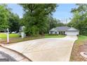 Long driveway leading to a charming home surrounded by lush greenery offering privacy and a sense of tranquility at 344 Dylan Way, Mcdonough, GA 30252