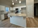 Bright kitchen with white cabinets, stainless steel appliances, granite countertops and an island at 344 Dylan Way, Mcdonough, GA 30252