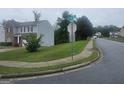 View down a residential street in the community showcasing well-manicured lawns and sidewalks at 7253 Lacey Dr, Douglasville, GA 30134