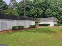 Spacious backyard with a white brick fence and plenty of room for outdoor activities at 7640 Ryefield Dr, Sandy Springs, GA 30350