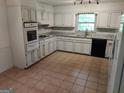 Functional kitchen with white cabinets, granite countertops, and modern appliances at 7640 Ryefield Dr, Sandy Springs, GA 30350