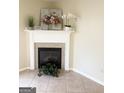Cozy fireplace with decor, tile flooring, adding warmth and charm to the living space at 2517 Walter Way, Stockbridge, GA 30281