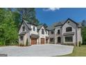 Spacious home with a three-car garage and ample driveway space, perfect for car enthusiasts or large families at 10765 Shallowford Rd, Roswell, GA 30075