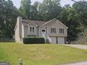 Inviting split-level home with a well-maintained lawn, two-car garage, and traditional architectural details at 54 Crestwood Dr, Dallas, GA 30157