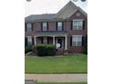 Charming two-story brick home with a classic design, black shutters, and well-maintained front yard at 2667 Hampton Park Dr, Marietta, GA 30062