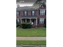 Charming two-story brick home with a classic design, black shutters, and well-maintained front yard at 2667 Hampton Park Dr, Marietta, GA 30062