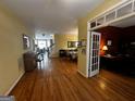 Sunlit open-plan living area with hardwood floors and seamless flow into dining and office spaces at 2667 Hampton Park Dr, Marietta, GA 30062