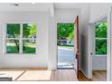 Bright entryway with hardwood floors, white walls, and a large window with a view of the front yard at 1835 Taylor Ave, East Point, GA 30344