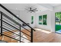 Bright living room featuring a modern fireplace, large windows, hardwood floors, and a ceiling fan at 1835 Taylor Ave, East Point, GA 30344