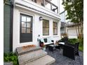 Stylish front entry with outdoor seating, providing a welcoming and comfortable space for guests to relax and enjoy the outdoors at 756 Cady Way, Atlanta, GA 30312