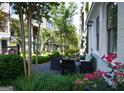 Inviting outdoor seating area surrounded by lush greenery and colorful flowers, perfect for relaxation and entertaining guests at 756 Cady Way, Atlanta, GA 30312