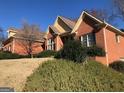 Brick home boasts mature landscaping and architectural details, offering a serene view at 116 Royal Burgess Way, Mcdonough, GA 30253