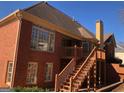 Brick home featuring large windows, deck with stairs, and a serene backyard at 116 Royal Burgess Way, Mcdonough, GA 30253