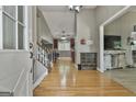 Warm and welcoming foyer with hardwood floors and an open staircase at 109 Cannon Rd, Sharpsburg, GA 30277