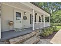 Inviting front porch with stone accents and decorative hanging flower baskets at 109 Cannon Rd, Sharpsburg, GA 30277