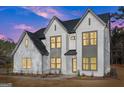 Charming two-story home featuring white brick and contrasting trim under a colorful sky at 3735 Tamiami Trl, Cumming, GA 30041