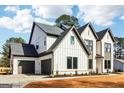 Spacious three-car garage with dark doors complementing the home's exterior at 3735 Tamiami Trl, Cumming, GA 30041