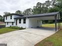 The spacious carport has ample parking and lighting, and an entry door to the home at 7340 Chalk Way, Riverdale, GA 30296
