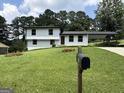 Inviting two-story home featuring fresh landscaping and a mailbox at 7340 Chalk Way, Riverdale, GA 30296