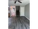 Inviting living room with modern gray floors, a ceiling fan, and a staircase leading to the upper level at 2754 Vining Ridge Terrace, Decatur, GA 30034