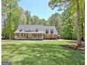 Traditional brick home with a sprawling front yard and a welcoming front porch at 315 Antebellum Way, Fayetteville, GA 30215