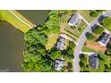 A captivating aerial view of a neighborhood, showcasing meticulously manicured lawns and serene lake at 255 Hidden Lake Dr, Fayetteville, GA 30215