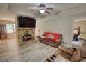 Cozy living room with stone fireplace, a flat screen television and comfortable seating, newly remodeled with modern floors at 1638 River Trc, Auburn, GA 30011