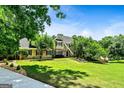 A stunning home with professional landscaping and a lush, green lawn at 324 Chimney Sweep Cir, Peachtree City, GA 30269