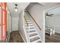 Inviting foyer with a staircase leading upstairs and views into the dining room at 120 Bowfin Bay, Peachtree City, GA 30269