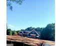 New construction home featuring a craftsman style exterior and dark roof nestled in a wooded neighborhood at 1273 Jersey Social Circle Rd, Covington, GA 30014