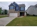 Lovely home with two-car garage, stone and blue siding, and a well-maintained lawn; perfect for Gathering living at 1946 Jeffery Nw Rd, Atlanta, GA 30318