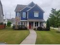Beautiful two-story home with stone and blue siding, a well-kept lawn, and a inviting walkway to the entry at 1946 Jeffery Nw Rd, Atlanta, GA 30318