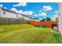 Backyard featuring a lawn, privacy fence, and lush greenery at 1562 Onalee Dr, Hampton, GA 30228