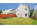 Backyard featuring a lawn, privacy fence, and lush greenery providing shade at 1562 Onalee Dr, Hampton, GA 30228