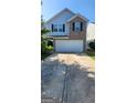 Two-story home with a brick facade, blue siding, and a two-car garage at 1562 Onalee Dr, Hampton, GA 30228