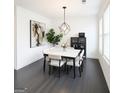 Bright dining room with modern lighting, abstract art, and a large window for natural light at 2282 Mclean Chase Se, Smyrna, GA 30080