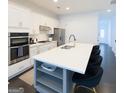 Modern kitchen with a large island, quartz countertops, stainless steel appliances, and a sleek faucet at 2282 Mclean Chase Se, Smyrna, GA 30080
